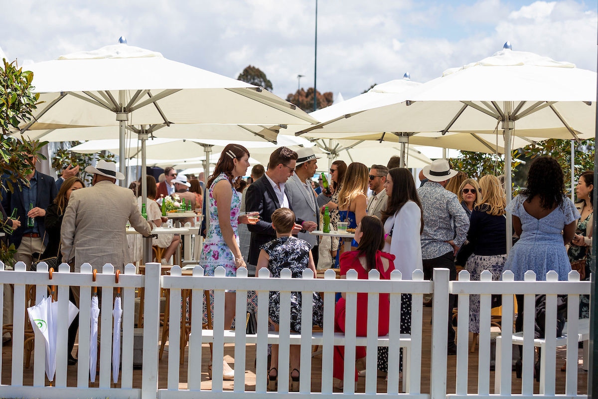 People gathering under a tent