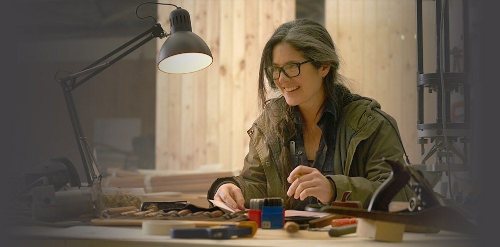 Person at table with wood tools