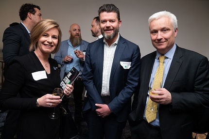 People in suit enjoying a glass of wine