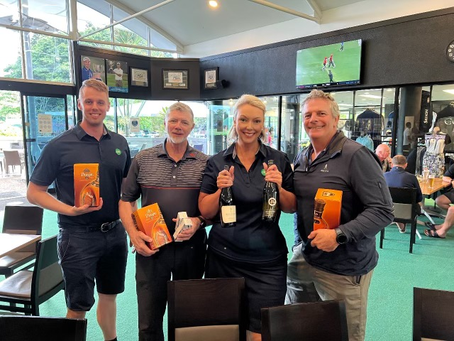 Guys with their awards smiling by the bar