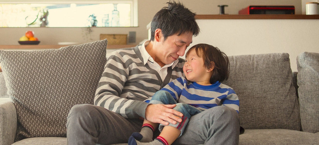 Child sitting on dads lap