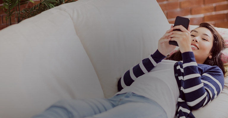 Girl laying on the couch with phone