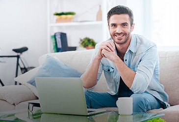 Guy with laptop on the couch