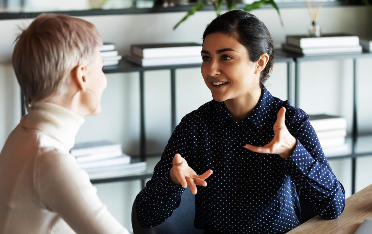 Two colleague having a chat in office workspace