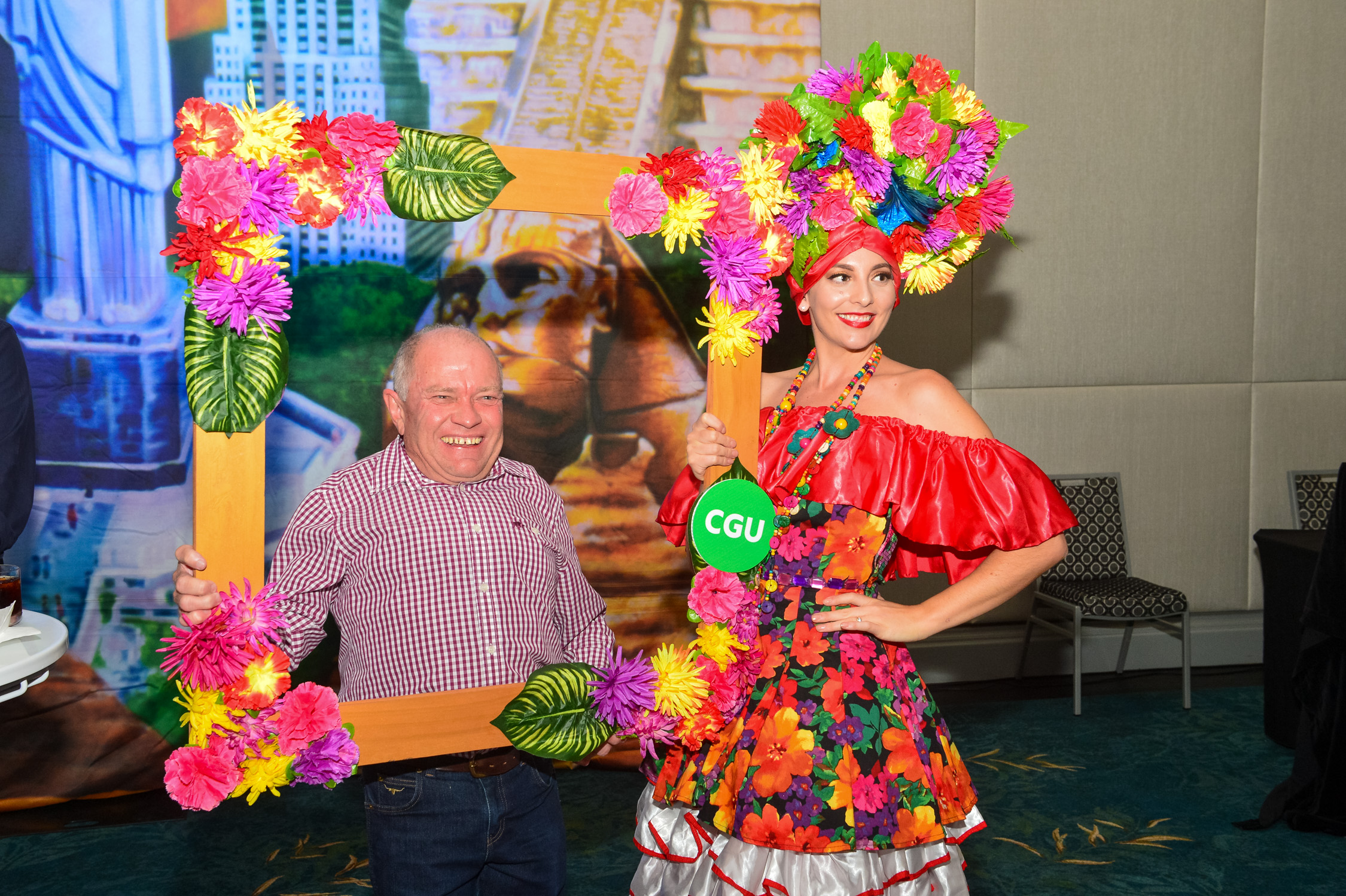 A guy in red striped shirt holding a flower frame boarder