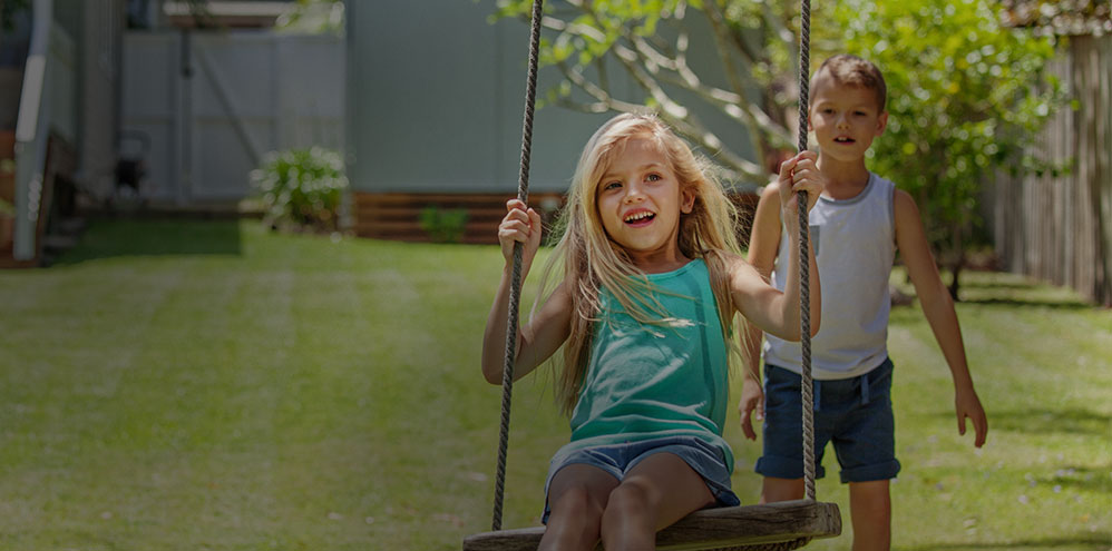 Boy pushing girl on the swing