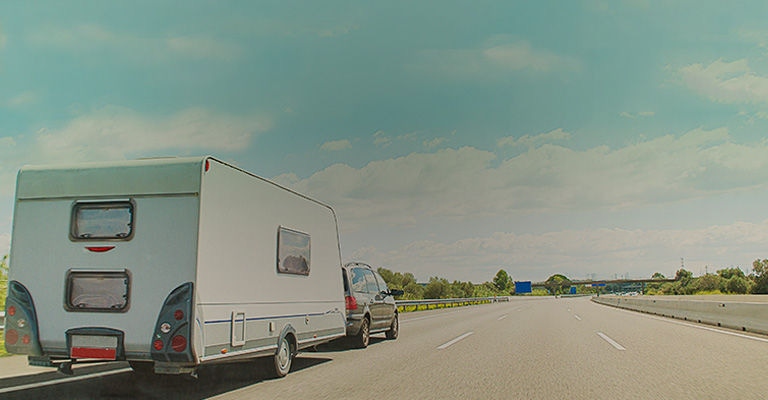 Vehicle with caravan trailer on the road