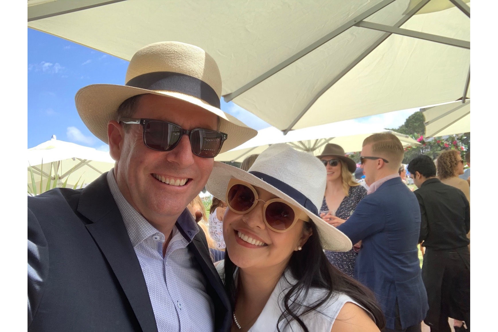 Two people wearing hat and sunglass on a sunny day