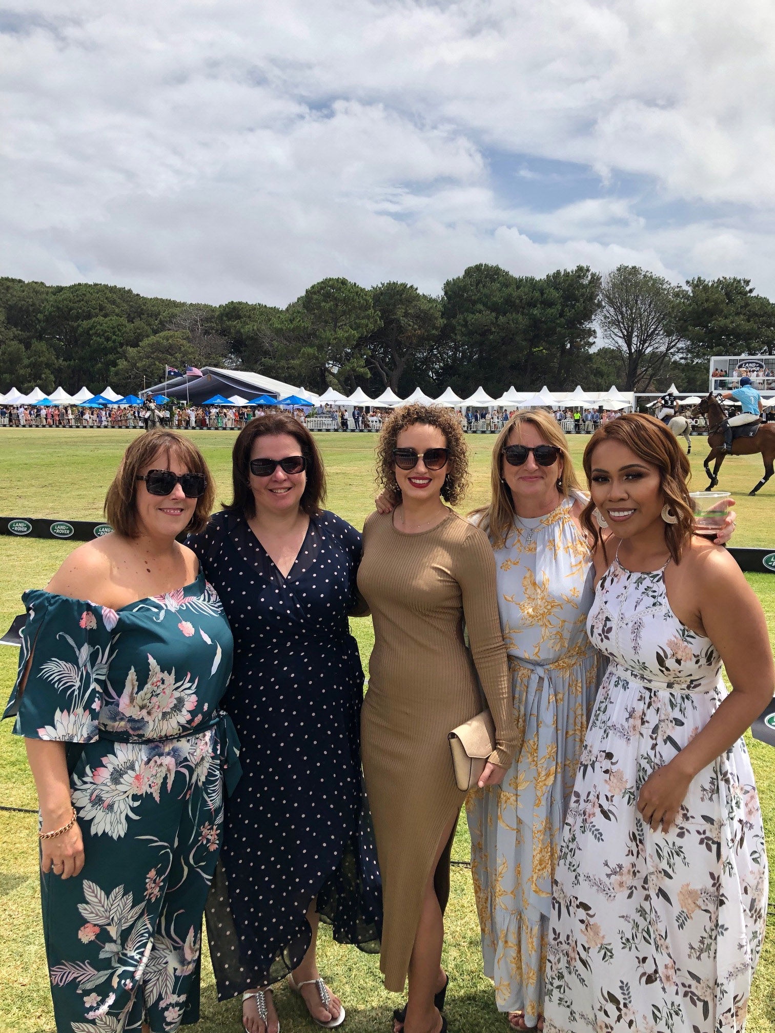 Ladies in dresses attending an horse event