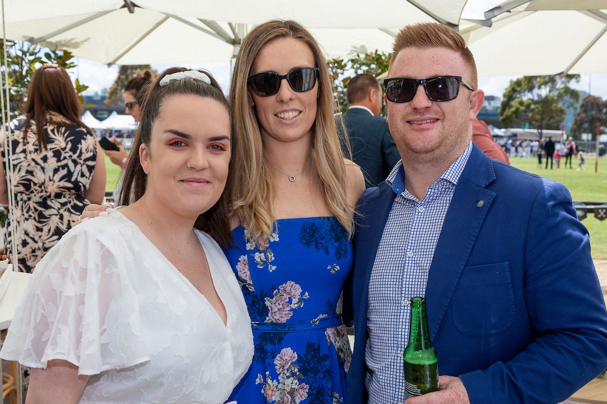 Guy with a beer pictured with two other ladies