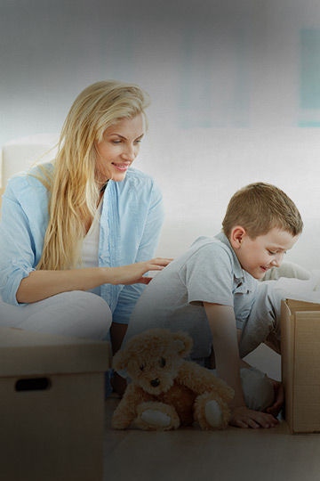 Son smiling while looking in the box